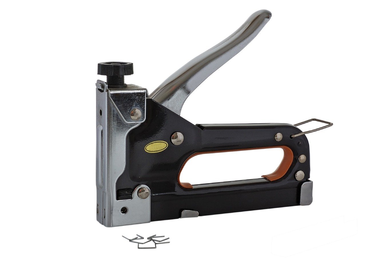 A black, grey, and brown staple gun with staples on the side